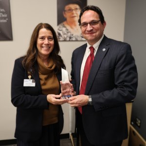 WHA President and CEO Eric Borgerding presents WHA’s 2023 Distinguished Service Award to Chris Woleske of Bellin and Gundersen Health System.